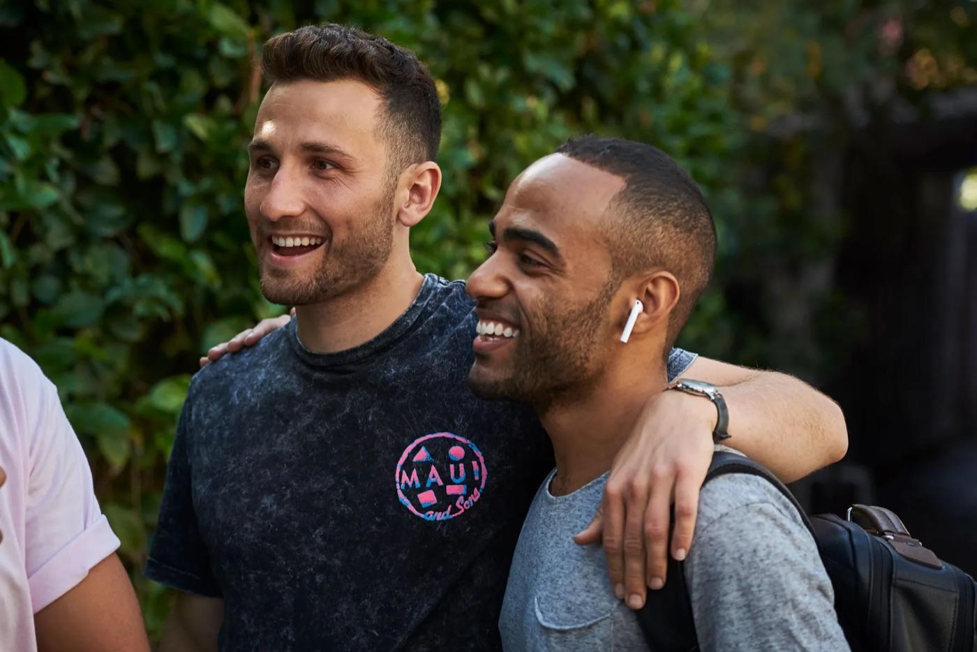 Jordan in conversation with a collaborator, arm around his shoulder.