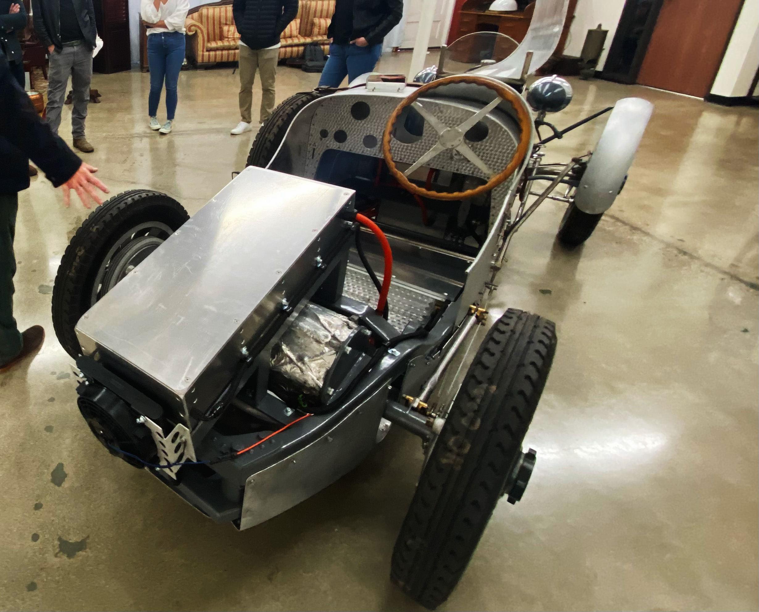 Vintage Bugatti chassis retrofitted with a Tesla battery pack and steel harness.